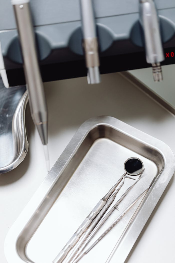 A vertical shot of dental instruments in a clinic setting, showcasing sterility and precision.